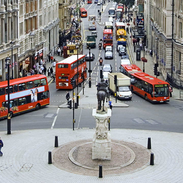 Iconic red double decker bus driving through London streets