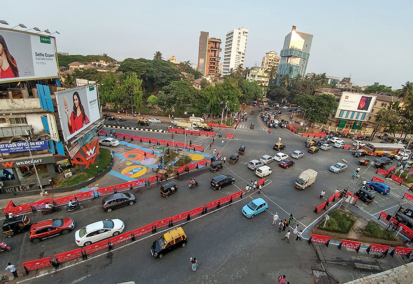 A busy intersection in Mumbai, India was redesigned with colorful barriers and crosswalks making pedestrians, cyclists, and drivers safer. Photo credit: WRI India