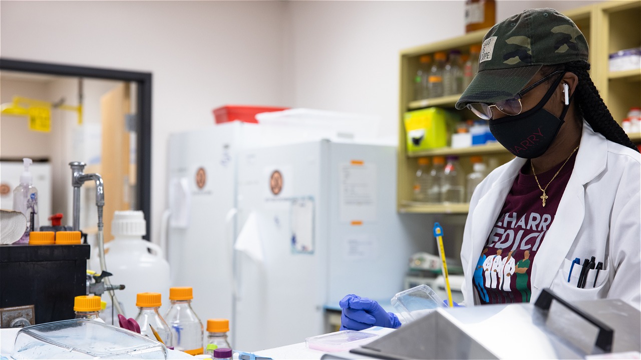 A Black medical school student from Meharry Medical College in a lab.